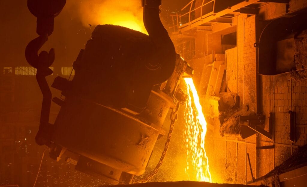Ladle pouring steel from crane